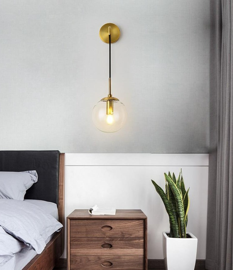 Black wall sconce mounted above a desk