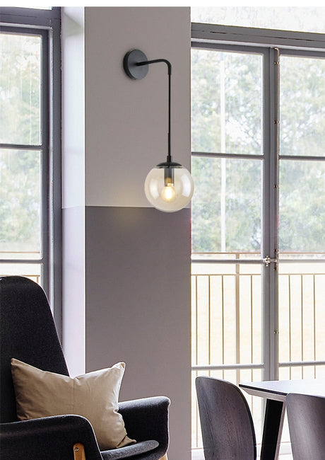 Amber glass shade on black wall sconce
