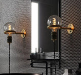 Wall sconce plugged in near a bed