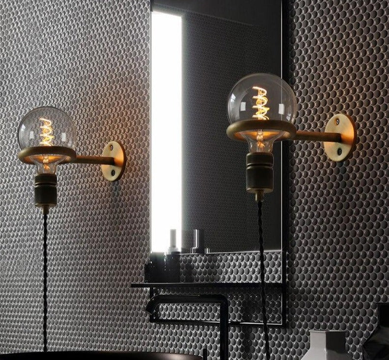 Wall sconce plugged in near a bed