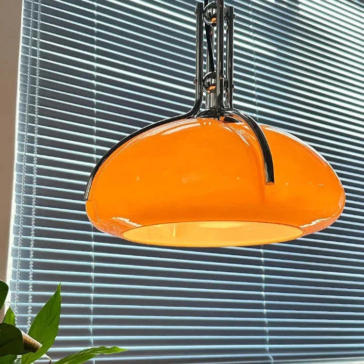 The orange shade lit beside a blue window blind in a bright room