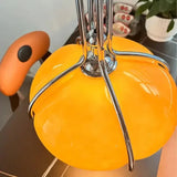 Close view of the ribbed orange glass with the chrome arm across it