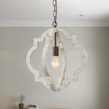 A single fitting lit against a soft green wall with a table below