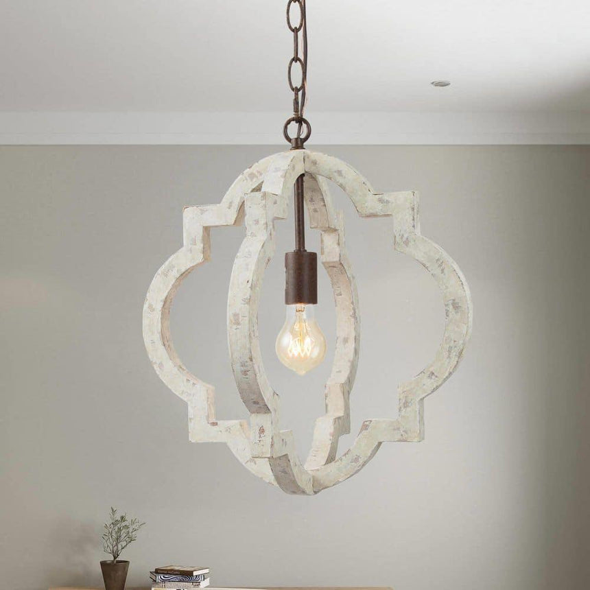 A single fitting lit against a soft green wall with a table below