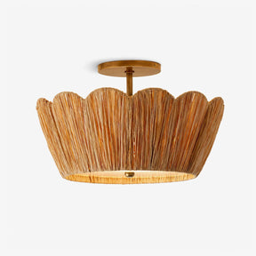 Raffia ceiling light with a handwoven scalloped shade and brass detail on a plain background