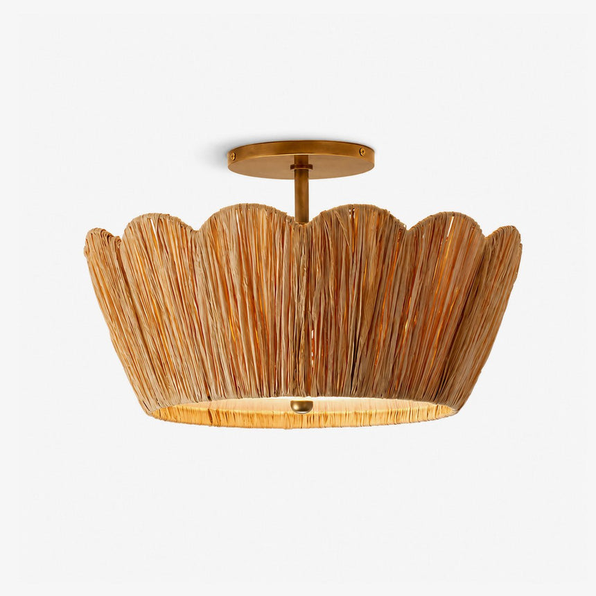 Raffia ceiling light with a handwoven scalloped shade and brass detail on a plain background