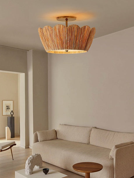 Raffia ceiling light in a living room with a long sofa and a round coffee table