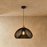 The same wide dome in black, the weave throwing a pattern on the plaster