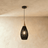 The same open weave in black, the shade drawn in as a tall narrow lantern