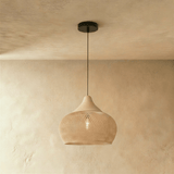 A natural rattan lantern shade, openly woven, glowing from the lamp inside it