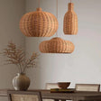 Round and teardrop woven shades above a dining table