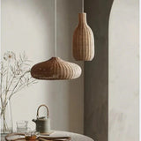 Low woven dome beside a tall teardrop shade in a gray room