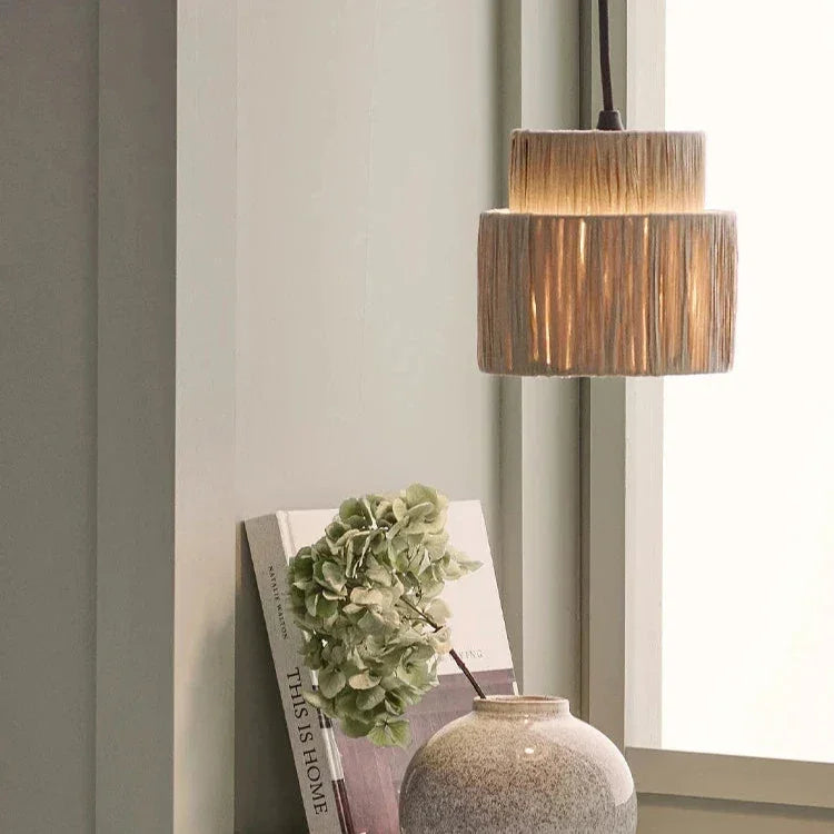 Rattan drum pendant light in a bedroom beside a mirror