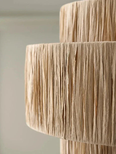 Several rattan drum pendant lights hung in a row