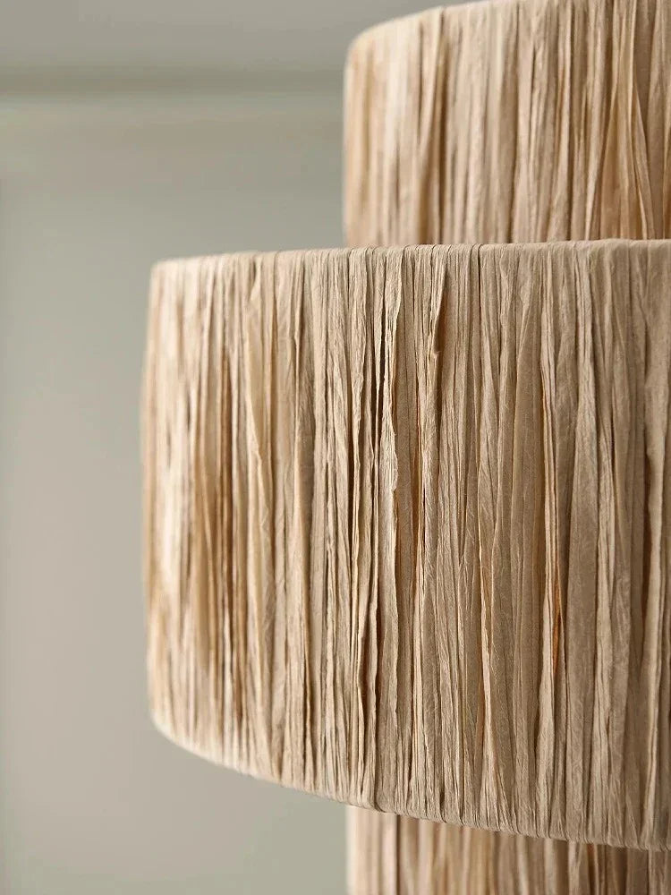 Several rattan drum pendant lights hung in a row