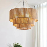 Rattan drum pendant light on a plain background showing the full three tier shape