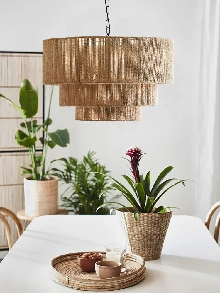 Rattan drum pendant light above a table with potted plants
