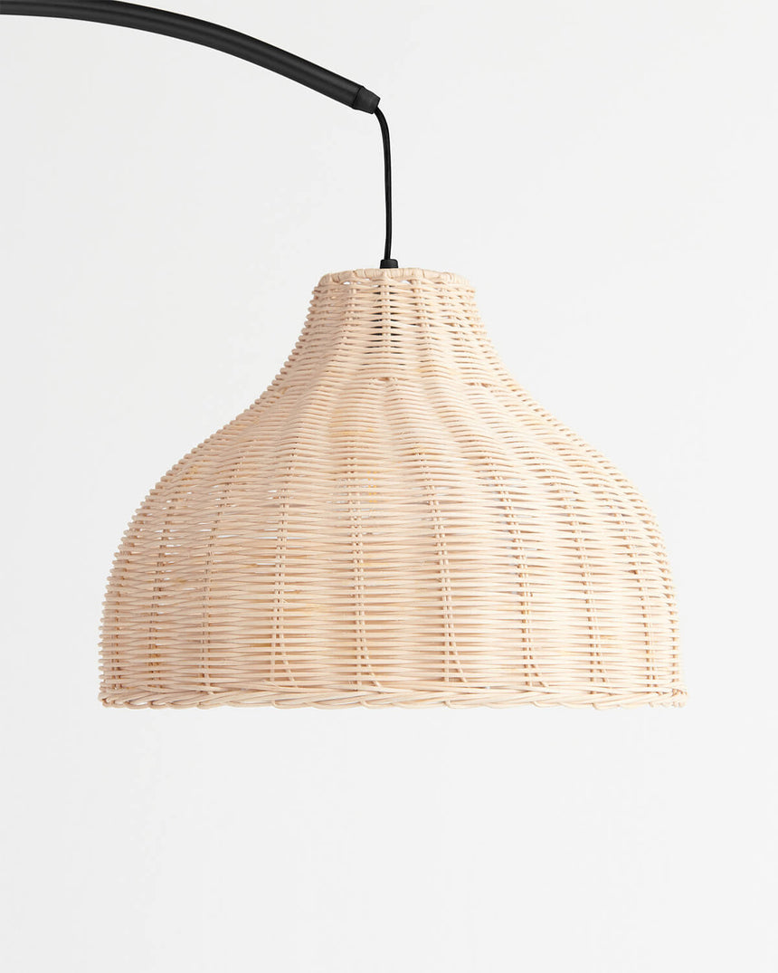The same woven shade on a black cord, the ribs of the weave lit from within
