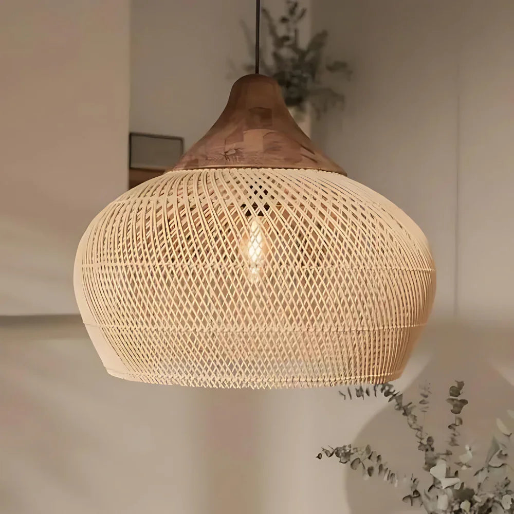 Rattan hanging light in a woven bell shape, natural finish, above a counter