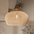 Rattan hanging light in a woven bell shape, natural finish, above a counter