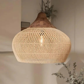 Rattan hanging light in a woven bell shape, natural finish, above a counter