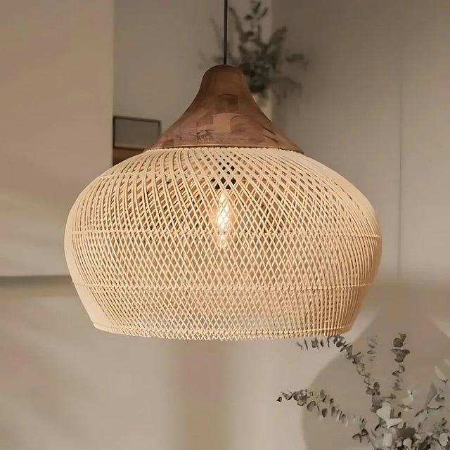 Rattan hanging light in a woven bell shape, natural finish, above a counter