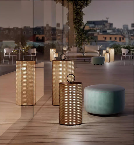 Lanterns lit along a city terrace with chairs and a low stool at night