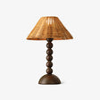 Table lamp with a woven rattan shade on a beaded walnut base
