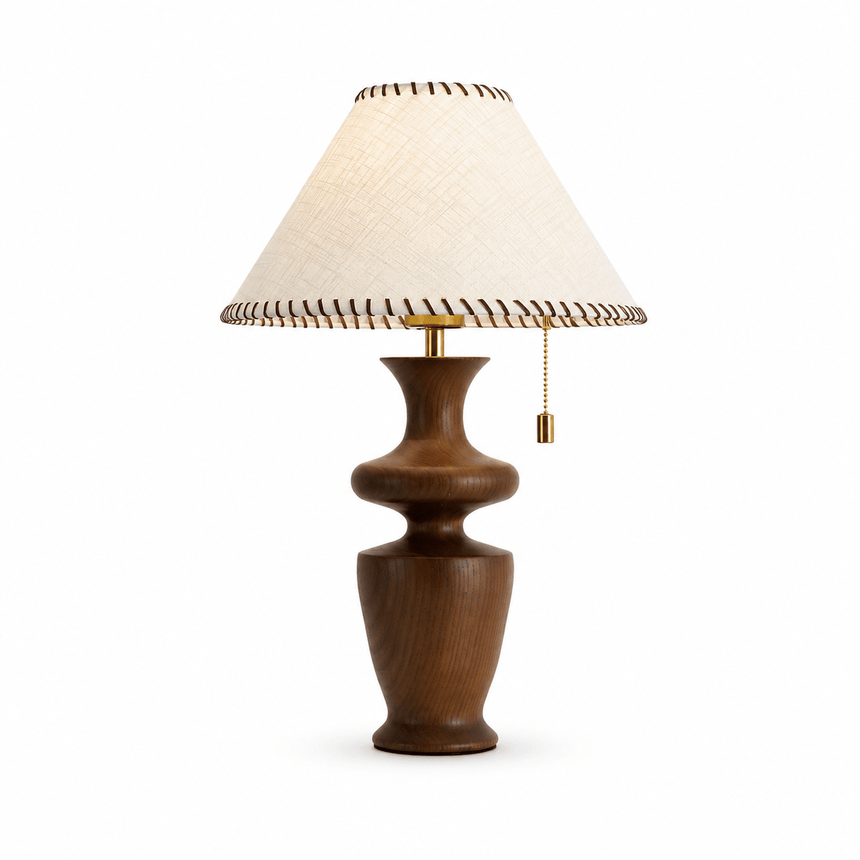 Table lamp with a woven fabric shade and leather trim, plain background