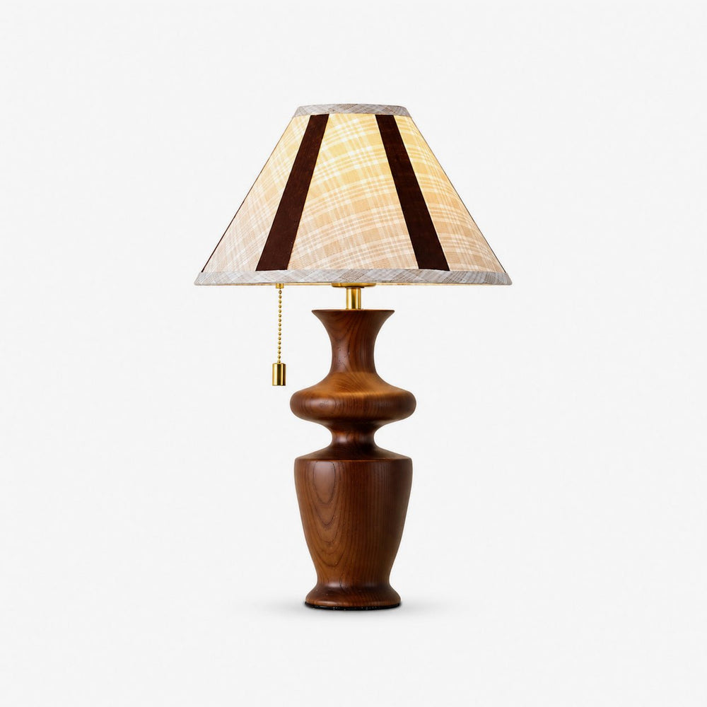 Table lamp with a plaid shade on a turned walnut baluster base, plain background