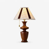 Table lamp with a plaid shade on a turned walnut baluster base, plain background