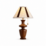 Close view of the plaid shade and the brass pull chain on the lamp body