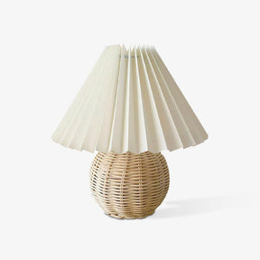 Rattan table lamp with a woven globe base and pleated shade, plain ground
