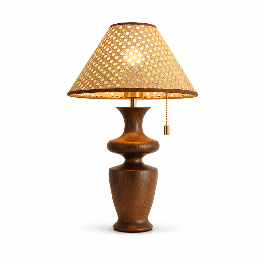 Rattan table lamp with the hand woven shade lit, plain background