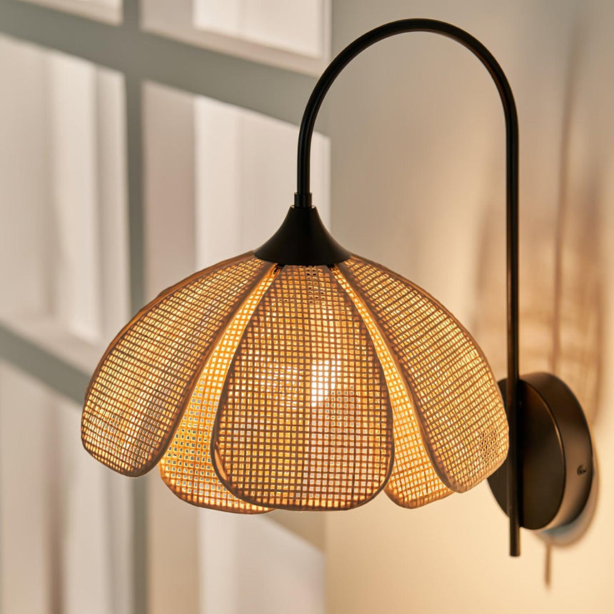 The petal shade seen close, the woven rattan and the scalloped edge