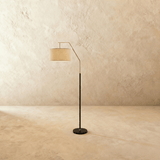The same lamp in black, the drum shade tilted forward on a short angled arm
