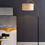 The lamp lit in a kitchen beside a counter with jars, artwork on a dark wall