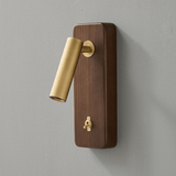 Close view of the brass head and toggle switch on a vertical wood plate