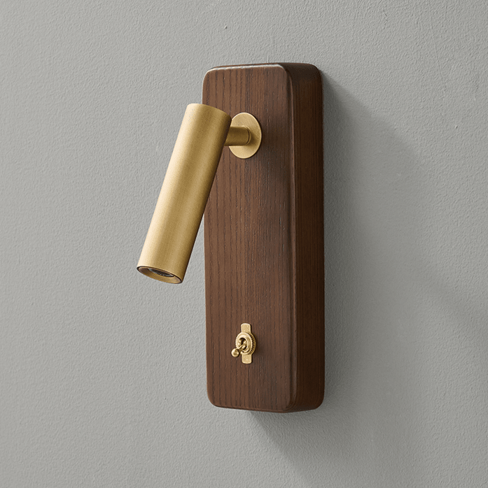 Close view of the brass head and toggle switch on a vertical wood plate