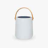 Small white cylinder lamp with a leather carry strap and a solar top