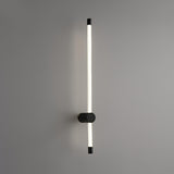 The black foot seen at an angle, the frosted tube rising past it on the wall