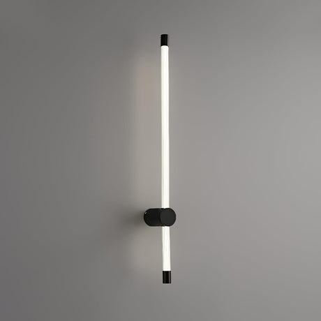 The black foot seen at an angle, the frosted tube rising past it on the wall