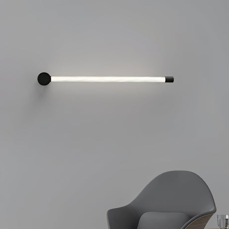 Mounted horizontally above a gray chair, the tube running level along the wall