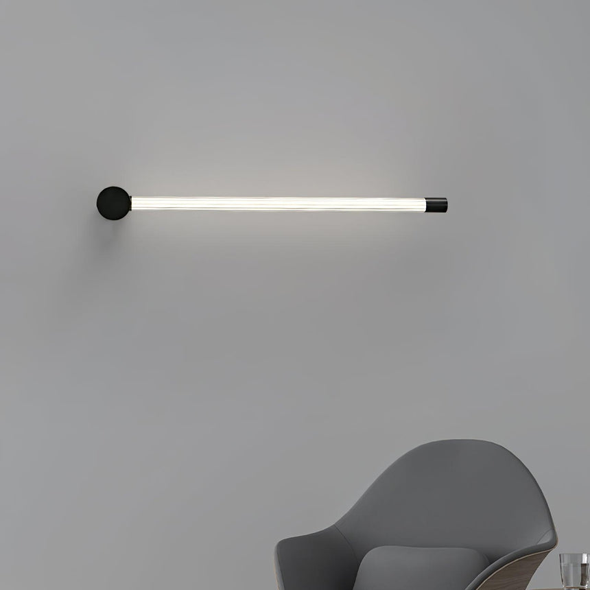 Mounted horizontally above a gray chair, the tube running level along the wall