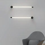 Two tubes mounted horizontally one above the other beside a gray armchair