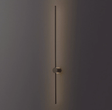 The black rod lit against a dark wall, the puck foot holding it clear