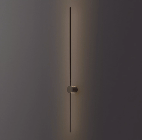 The black rod lit against a dark wall, the puck foot holding it clear