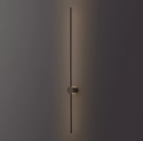 The black rod lit against a dark wall, the puck foot holding it clear