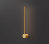 The copper puck foot seen close, the brushed metal lit from the rod above