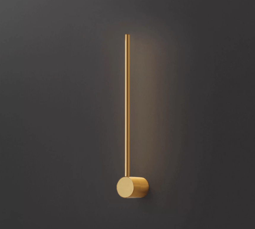 The copper puck foot seen close, the brushed metal lit from the rod above